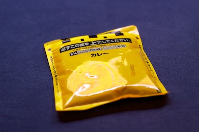 Japanese curry in a bright yellow plastic bag